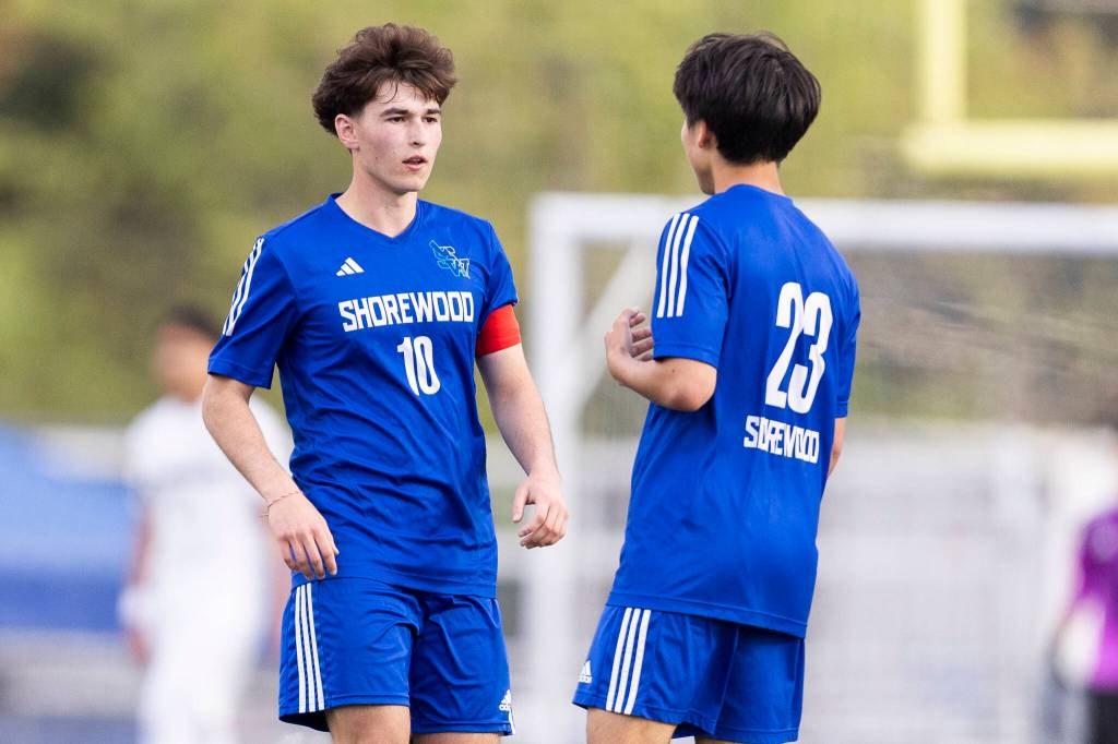 Shorewoods Nikola Genadiev and Shorewoods Ian Baxter talk during the 3A district semifinal game against Lynnwood on Tuesday, May 12, 2026 in Shoreline, Washington. (Olivia Vanni / The Herald)