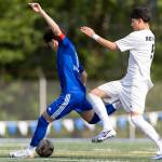 Shorewoods Nikola Genadiev takes a shot while Lynnwoods Vincent Ortega tries to defend during the 3A district semifinal game on Tuesday, May 12, 2026 in Shoreline, Washington. (Olivia Vanni / The Herald)