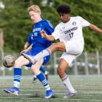 Lynnwoods Natan Kiflemariam takes a shot while Shorewoods Jack Delachapelle defends during the 3A district semifinal game on Tuesday, May 12, 2026 in Shoreline, Washington. (Olivia Vanni / The Herald)