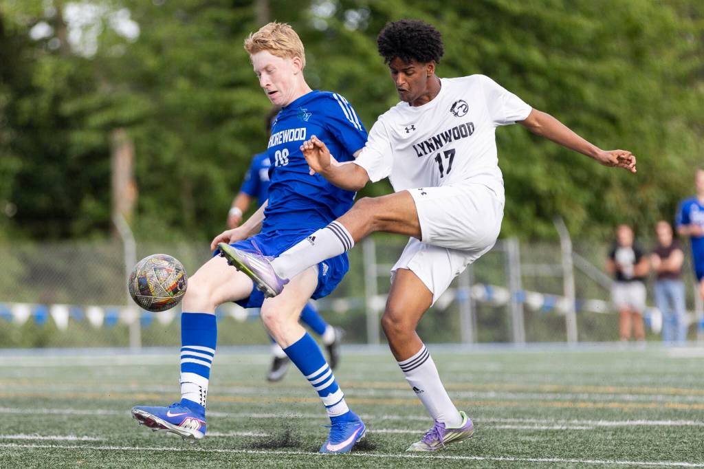 Lynnwoods Natan Kiflemariam takes a shot while Shorewoods Jack Delachapelle defends during the 3A district semifinal game on Tuesday, May 12, 2026 in Shoreline, Washington. (Olivia Vanni / The Herald)