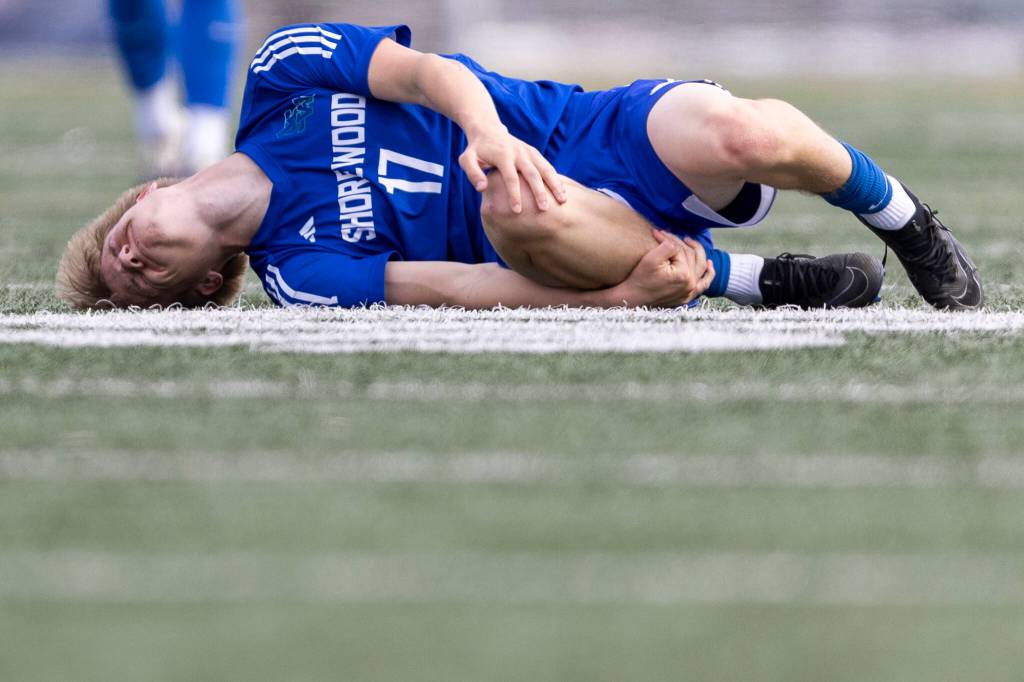Shorewoods Julian Shook grabs his knee after drawing a foul during the 3A district semifinal game against Lynnwood on Tuesday, May 12, 2026 in Shoreline, Washington. (Olivia Vanni / The Herald)