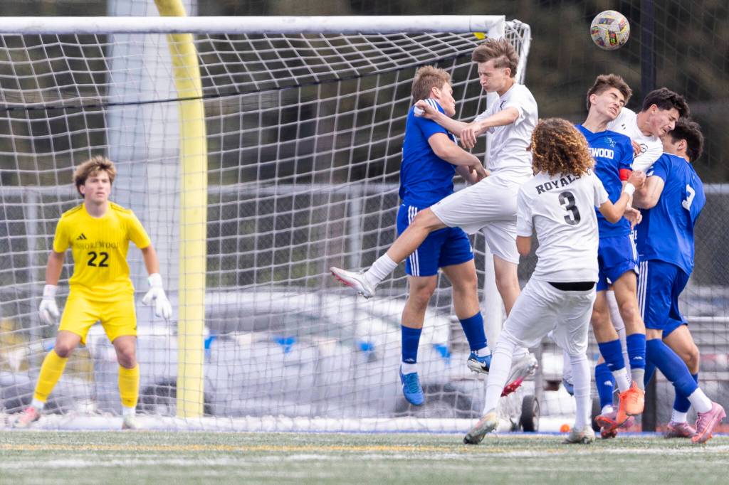 Shorewood and Lynnwood players jump up for a corner kick during the 3A district semifinal game on Tuesday, May 12, 2026 in Shoreline, Washington. (Olivia Vanni / The Herald)