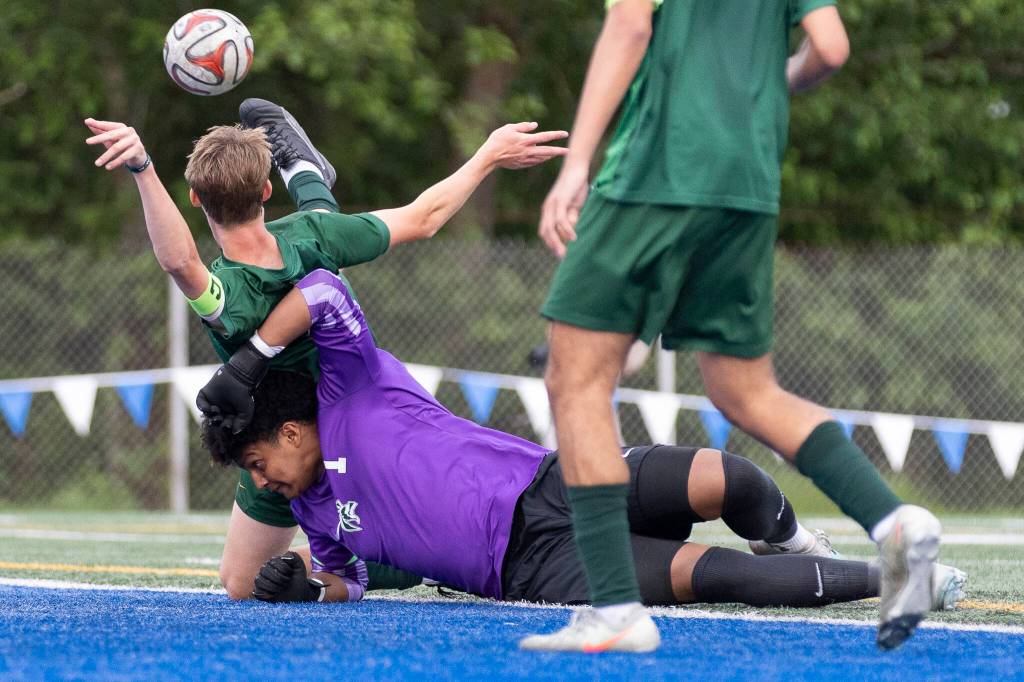 Edmonds-Woodways Isaiah Zabel and Shorecrests Ashton Johnson collide in the goal box during the 3A district semifinal game on Tuesday, May 12, 2026 in Shoreline, Washington. (Olivia Vanni / The Herald)