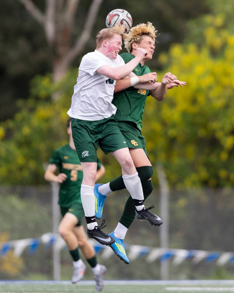 Edmonds-Woodways Jonah Sutcliffe and Shorecrests Cole Ambrose jump up to head the ball during the 3A district semifinal game on Tuesday, May 12, 2026 in Shoreline, Washington. (Olivia Vanni / The Herald)