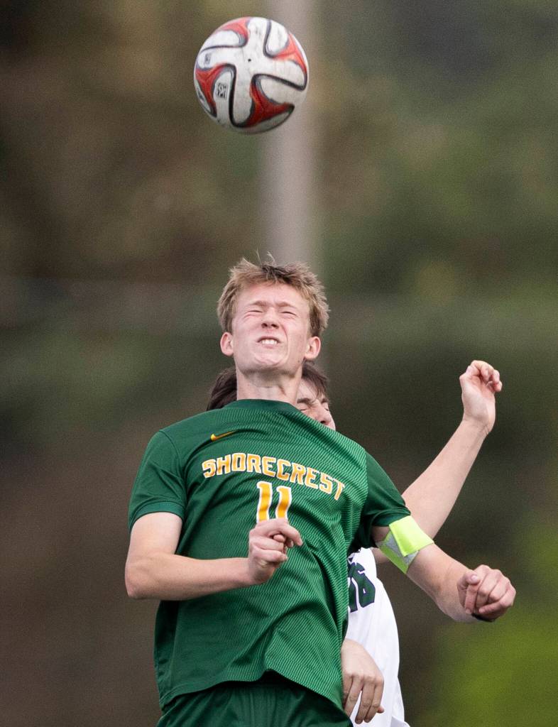 Shorecrests Ashton Johnson jumps up to head the ball during the 3A district semifinal game on Tuesday, May 12, 2026 in Shoreline, Washington. (Olivia Vanni / The Herald)