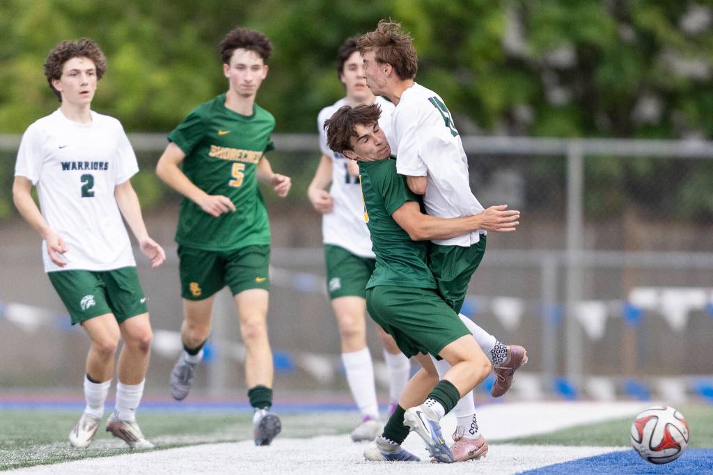 Edmonds-Woodways Mason Clark and Shorecrests Kai Short collide during the 3A district semifinal game on Tuesday, May 12, 2026 in Shoreline, Washington. (Olivia Vanni / The Herald)