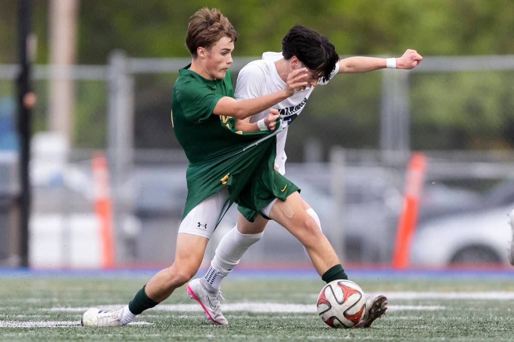 Edmonds-Woodways Jackson Cho grabs the uniform of Shorecrests Drew Mathieson as they battle for the ball during the 3A district semifinal game on Tuesday, May 12, 2026 in Shoreline, Washington. (Olivia Vanni / The Herald)