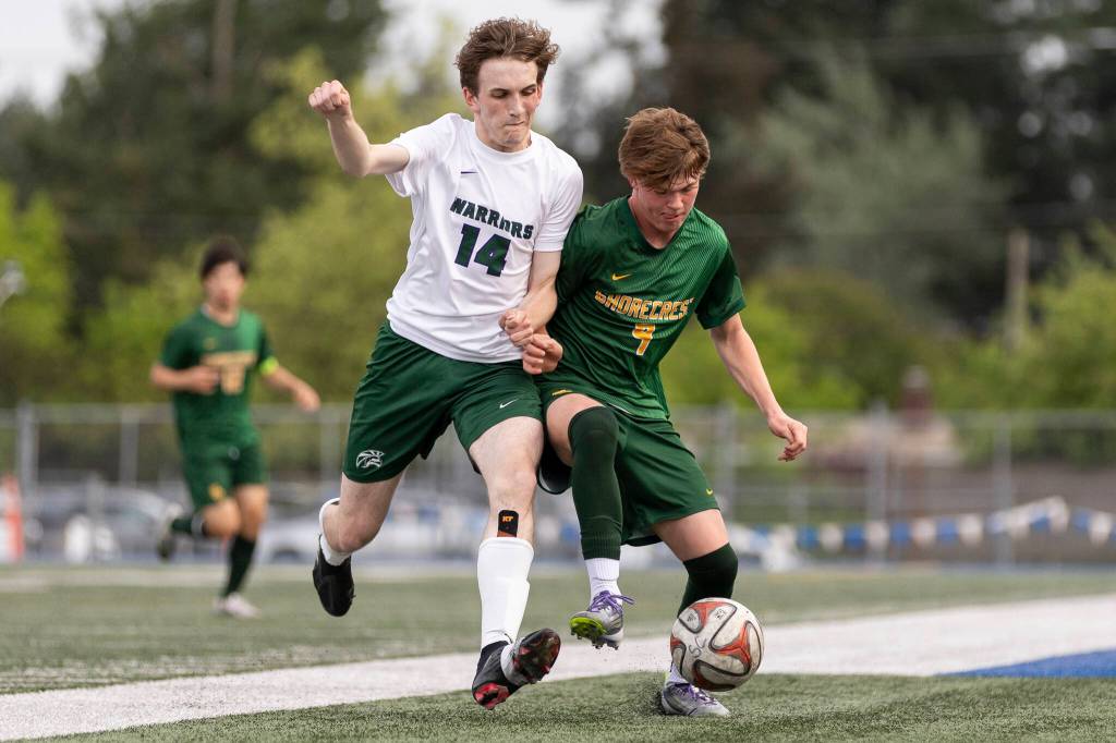 Edmonds-Woodways Will Bourbonnais and Shorecrests Kai Short battle for the ball during the 3A district semifinal game on Tuesday, May 12, 2026 in Shoreline, Washington. (Olivia Vanni / The Herald)