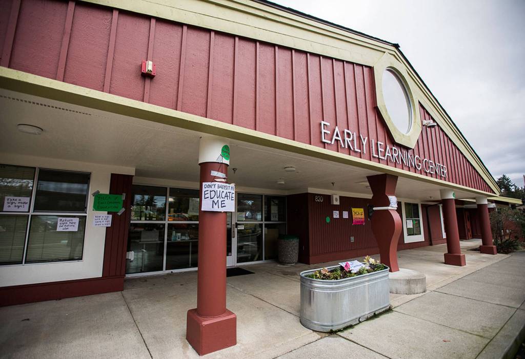 Signs hang on the outside of the Early Learning Center on the Everett Community College campus on Wednesday, Dec. 1, 2021 in Everett, Wa. (Olivia Vanni / The Herald)