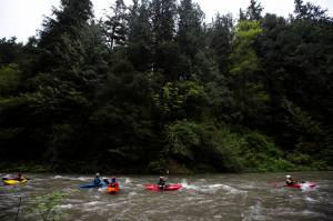 Kayakers make their way down the Sultan River after walking around the Diversion Dam on Saturday, May 22, 2021 in Sultan, Wash. (Olivia Vanni / The Herald)
