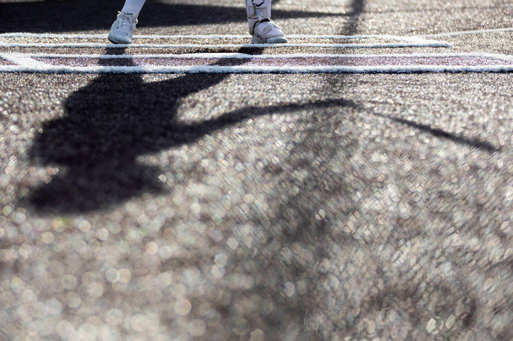A batter at home plate casts a shadow during the 3A district championship between Sedro-Woolley and Everett on Thursday, May 14, 2026 in Everett, Washington. (Olivia Vanni / The Herald)