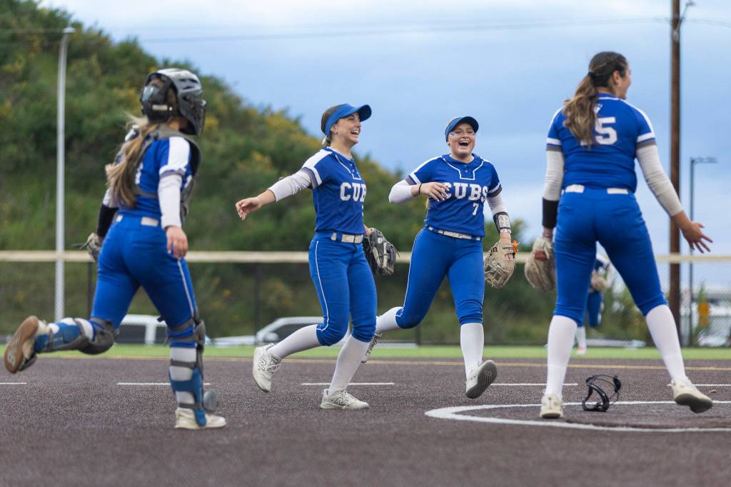 Sedro-Woolley players react after beating Everett in the 3A district championship game on Thursday, May 14, 2026 in Everett, Washington. (Olivia Vanni / The Herald)