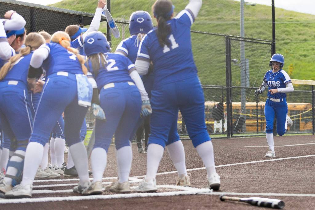 Sedro-Woolleys Veanna Lanphere runs toward her teammates surrounding home plate after hitting a home run during the 3A district championship game against Everett on Thursday, May 14, 2026 in Everett, Washington. (Olivia Vanni / The Herald)