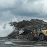 A front-end loader moves around material piles at Cedar Grove on Thursday, May 14, 2026 in Everett, Washington. (Olivia Vanni / The Herald)