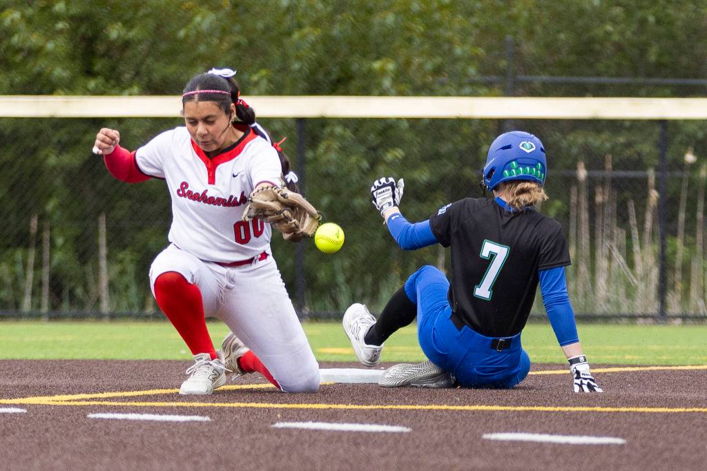 Shorewoods Alyssa Carver slides safely into second base as the ball misses the glove of Snohomishs Amelie Lopez during the 3A district loser-out game on Thursday, May 14, 2026 in Everett, Washington. (Olivia Vanni / The Herald)