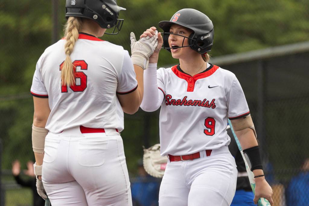Snohomishs Abby Edwards high fives teammates Snohomishs Rhys Doyle during the 3A district loser-out game against Shorewood on Thursday, May 14, 2026 in Everett, Washington. (Olivia Vanni / The Herald)