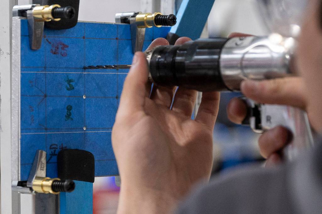 A pre-apprentice pre-drills a hole during a training at the Machinists Institute Everett on Thursday, May 21, 2026 in Everett, Washington. (Olivia Vanni / The Herald)