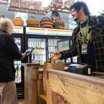 Front end manager Ky Taylor bags groceries for a customer at Sno-Isle Food Co-op on Wednesday, May 20, 2026 in Everett, Washington. (Olivia Vanni / The Herald)