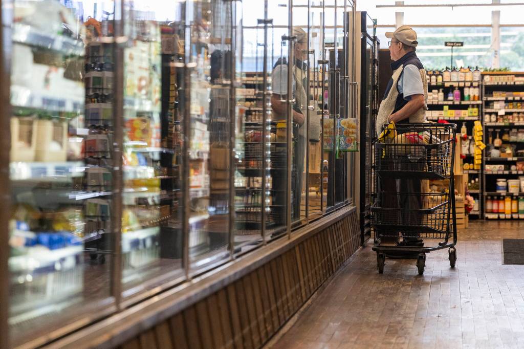 A customer looks at the ice cream selection at the Sno-Isle Food Co-op on Wednesday, May 20, 2026 in Everett, Washington. (Olivia Vanni / The Herald)
