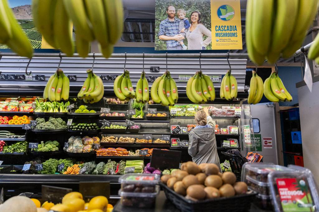 A customer looks at the produce section at the Sno-Isle Food Co-op on Wednesday, May 20, 2026 in Everett, Washington. (Olivia Vanni / The Herald)