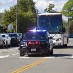 Receiving a police escort, the Everett Silvertips team bus arrives at Everett High School on May 16, 2026. (Joe Pohoryles / The Herald)