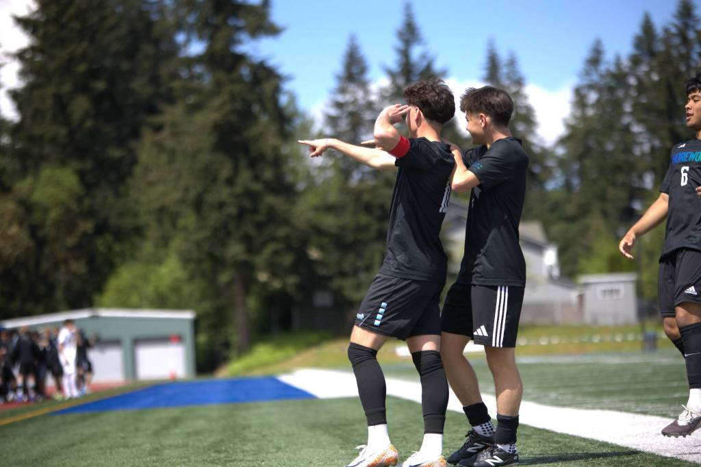 Shorewood forward Nikola Genadiev points to the crowd after scoring off a free kick during the District 1 3A Tournament title game against Shorecrest on Saturday, May 16, 2026 at Shoreline Stadium in Shoreline. (Qasim Ali / The Herald)