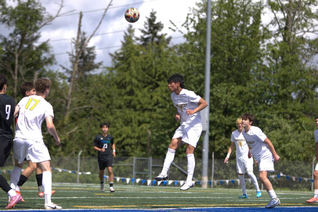Shorecrest defender Maceo Jala leaps to head the ball away during the District 1 3A Tournament title game against Shorewood on Saturday, May 16, 2026 at Shoreline Stadium in Shoreline. (Qasim Ali / The Herald)