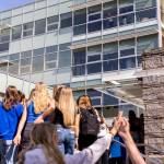 People inside Bothell City Hall look out over the crowd of Bothell High School students and other community members protesting the school boards vote to not renew the contract for the high schools school resource officer on Monday, May 18, 2026, in Bothell, Washington. (Olivia Vanni / The Herald)