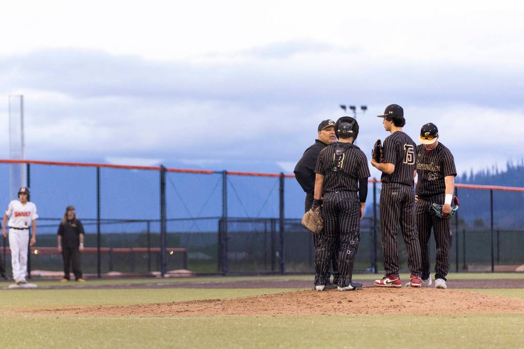 Enumclaw head coach Jamey Ingersoll talks with his pitcher Thade Highfill with the bases loaded in the seventh inning during the 3A state opening round loser-out game against Monroe on Tuesday, May 19, 2026 in Monroe, Washington. (Olivia Vanni / The Herald)
