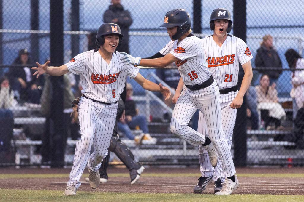 Monroes Mike Enrico celebrates teammate Joe Enrico scoring due to a balk by the Enumclaw pitcher with bases loaded to win the 3A state opening round loser-out game on Tuesday, May 19, 2026 in Monroe, Washington. (Olivia Vanni / The Herald)