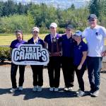The Kamiak girls golf team, from left to right: freshman Wonnie Lee, freshman Noel Chong, junior Sarah Dyer, senior Ashtyn McClure, junior Allie Suh and coach Dan Murnan, won the 2026 WIAA 4A Girls State Championship at The Golf Club at Hawks Prairie in Lacey, Washington on May 20, 2026. (Joe Pohoryles / The Herald)