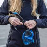 Annie Crawley puts on gear for a portrait at Brackett’s Landing near the Port of Edmonds on Saturday, Feb. 3, 2024 in Edmonds, Washington. (Annie Barker / The Herald)