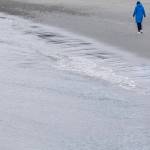 A person walks along the beach next to the Underwater Park on Thursday, Feb. 26, 2026 in Edmonds, Washington. (Olivia Vanni / The Herald)