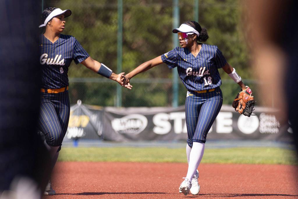 Everetts Akilah Shaw high fives teammate Everetts Ziarah Parker during the 3A state opening round loser-out game against Garfield on Friday, May 22, 2026 in Lacey, Washington. (Olivia Vanni / The Herald)