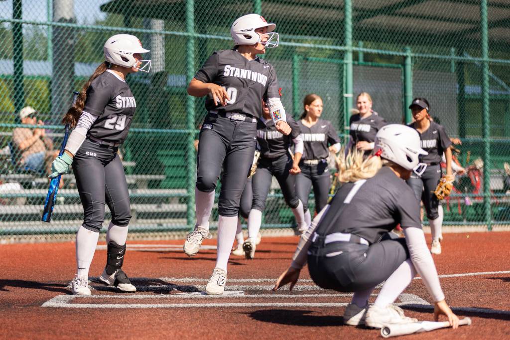 Stanwood crowds the plate to celebrate teammate Jordan Rancourts home run during the 3A state quarterfinal game against Kennewick on Friday, May 22, 2026 in Lacey, Washington. (Olivia Vanni / The Herald)