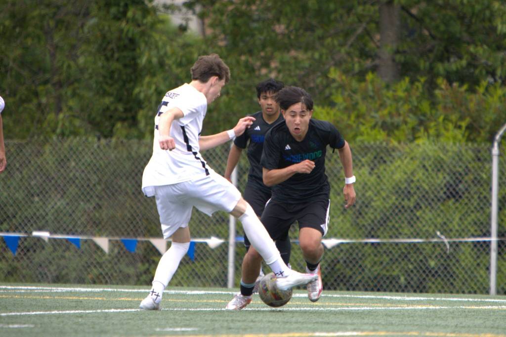 Shorewoods Ian Baxter tries to work past Eastside Catholics Jackson Leary during the first half of a state quarterfinal game on Saturday, May 23, 2026 at Shoreline Stadium in Shoreline. (Qasim Ali / The Herald)