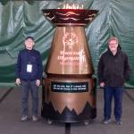 Doug Brown (left), an associate technical fellow in BCA engineering, and Perry Hoffman (right), Boeing transportation, stand next to the finished cauldron, which was unveiled Friday, May 29, 2026, in Tacoma, Washington. (Craig Larsen / Provided photo)