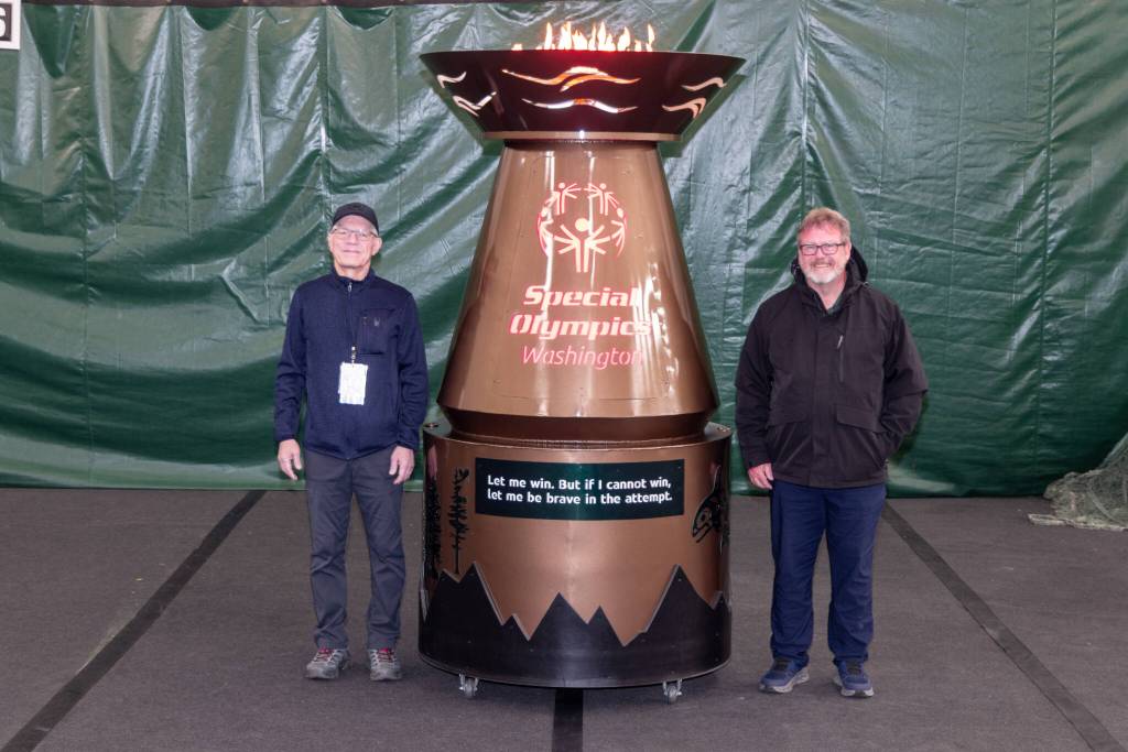 Doug Brown (left), an associate technical fellow in BCA engineering, and Perry Hoffman (right), Boeing transportation, stand next to the finished cauldron, which was unveiled Friday in Tacoma. (Craig Larsen / Provided photo)