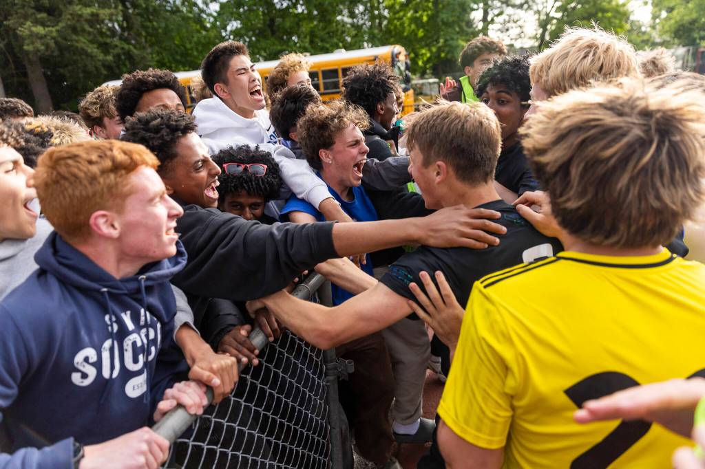 Shorewood fans celebrate with Shorewood players after beating Bishop Blanchet in a shootout to advance to the 3A state championship on Friday, May 29, 2026 in Puyallup, Washington. (Olivia Vanni / The Herald)