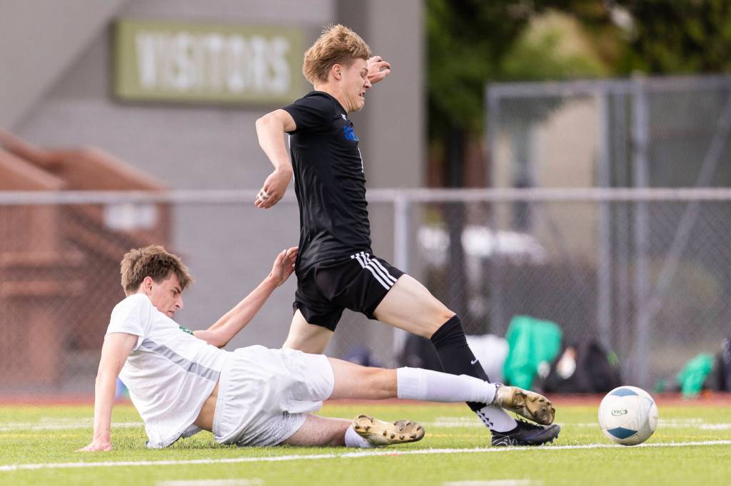 Shorewoods Julian Shook is slide tackled by Bishop Blanchets RJ McGrew in the box during the 3A state semifinal game on Friday, May 29, 2026 in Puyallup, Washington. (Olivia Vanni / The Herald)