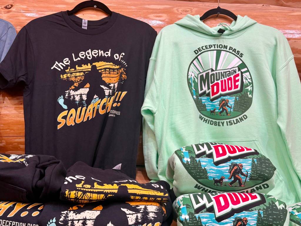 Souvenir shirts are among the many Bigfoot-themed items at Squatchys gift shop in Oak Harbor near Deception Pass State Park. (Andrea Brown / The Herald)
Souvenir shirts are among the many Bigfoot-themed items at Squatchys gift shop in Oak Harbor near Deception Pass State Park. (Andrea Brown / The Herald)