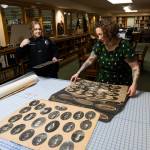 Will Geschke / The Herald 
Lisa Labovitch, right, pulls out archival photos of Everett police officers from the early 1900s in the Northwest Room of the Everett Public Library on Friday.