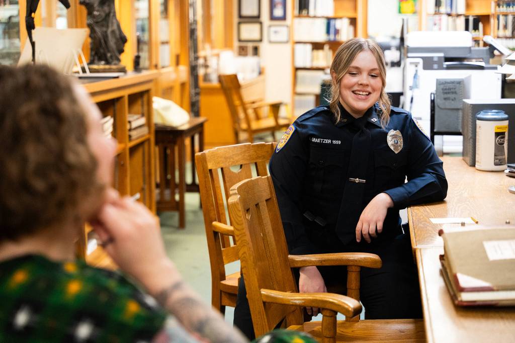 photos by Will Geschke / The Herald
Everett police officer Alisa Graetzer, right, who helped rediscover Charles Ed Rays death, speaks with Lisa Labovitch, left, a history specialist at the Everett Public Library on Friday, May 22, 2026.
