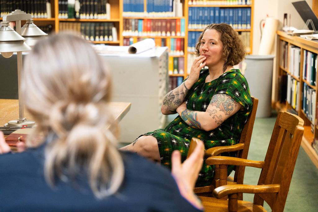 Lisa Labovitch, right, a history specialist at the Everett Public Library who helped research Charles Ed Rays background, speaks with Everett police officer Alisa Graetzer, left, in the Northwest Room of the Everett Public Library on May 22, 2026.