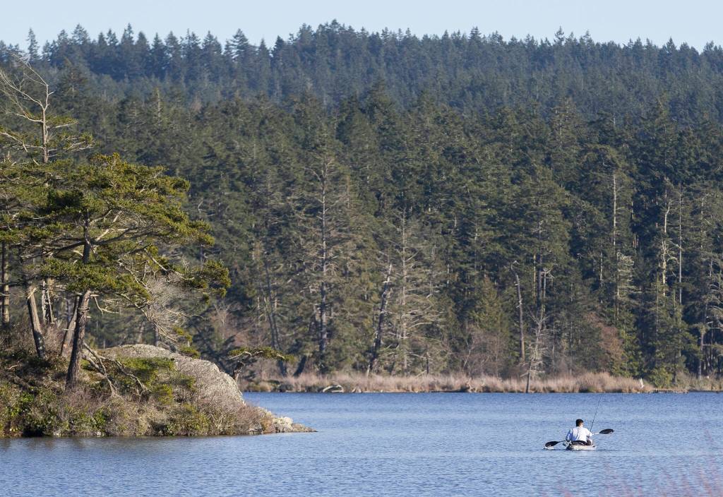 A person fishes on Cranberry Lake at Deception Pass State Park on Monday, March 2, 2026 in Oak Harbor, Washington. (Olivia Vanni / The Herald)