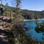 People look out over Bowman Bay from the Pacific Northwest Trail at Deception Pass State Park on Monday, March 2, 2026 in Anacortes, Washington. (Olivia Vanni / The Herald)