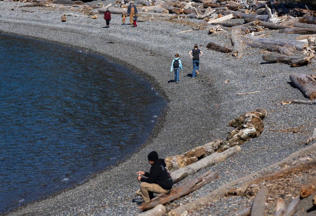 People walk along Rosario Beach on Monday, March 2, 2026 in Anacortes, Washington. (Olivia Vanni / The Herald)