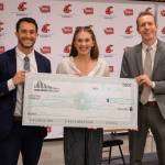 Future Leaders Academy essay winner Ashlynn Hager holds her awarded scholarship between Jared Mead and Nate Nehring during the Building Bridges Summit on Wednesday, May 27, 2026 at Washington State University Everett. (Provided photo)
