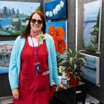 Mary Caroline Craig stands in her booth selling paintings during the Sorticulture gardening festival on Friday, June 5, 2026, in downtown Everett, Washington. (Will Geschke / The Herald)