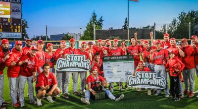 The Kings baseball team poses with their Class 1A state championship trophy on Saturday, May 30, 2026 at Joe Martin Stadium in Bellingham. (Courtesy of Kings H.S. Athletics)